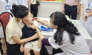 Bộ trưởng Bộ Y tế Đào Hồng Lan tự tay cho trẻ uống vitamin A