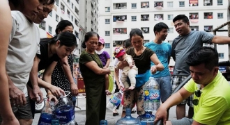 Người già bế cháu, xách xô xếp hàng chờ lấy nước sạch tại khu đô thị Linh Đàm – Hà Nội