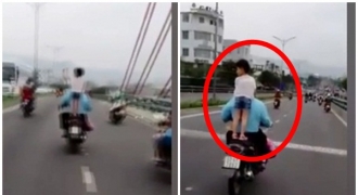 Cho trẻ nhỏ đầu trần đứng yên sau, người đàn ông vẫn phóng vèo vèo trên cầu Nhật Tân