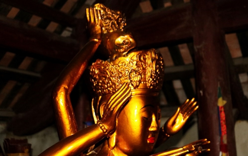 Phần trên của tượng Phật Mẫu Chuẩn Đề với khuôn mặt nhân từ đầu đội mũ hoa. Ảnh: Huy Thư