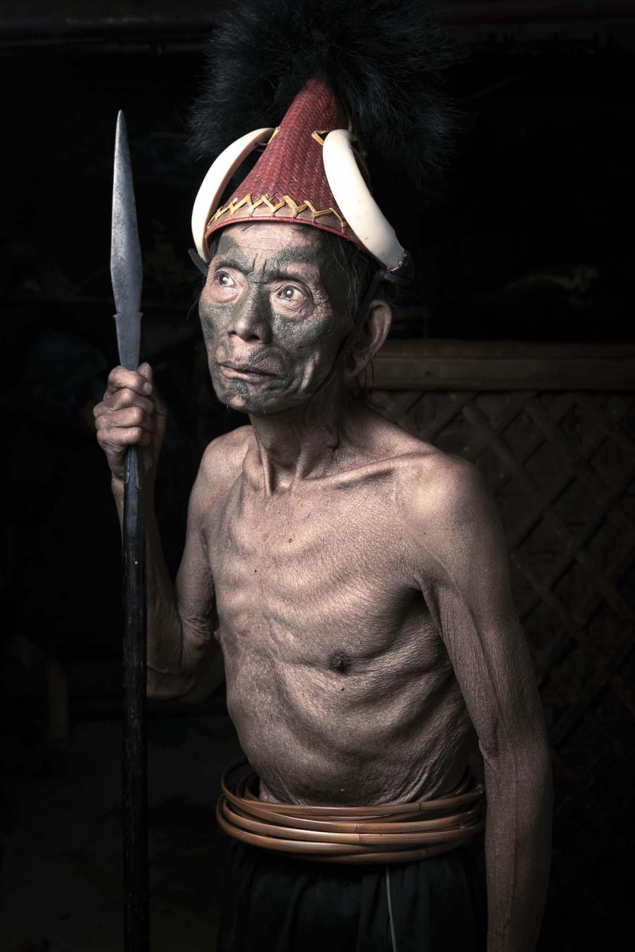 Manchak Wankongpa, 80 tuổi, đội một chiếc mũ được trang trí bằng hai ngà của một con lợn rừng.
