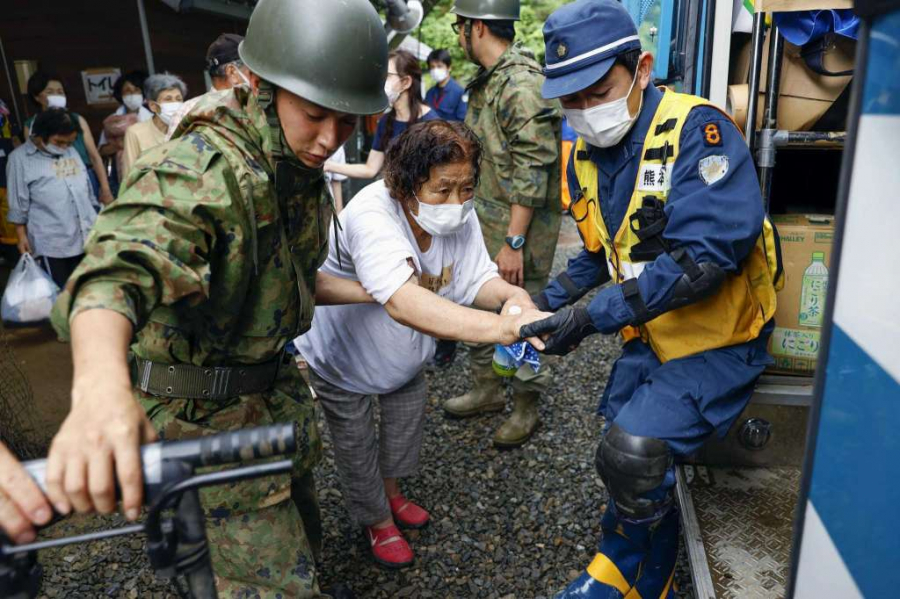 Nhân viên cứu hộ giúp đỡ nạn nhân tại thị trấn Kumamura, tỉnh Kumamoto