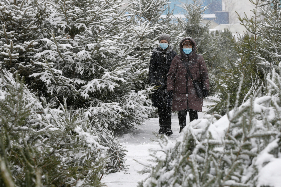 Đi dạo chợ cây Giáng sinh trong tuyết rơi ở Kyiv, Ukraine ngày 23/12