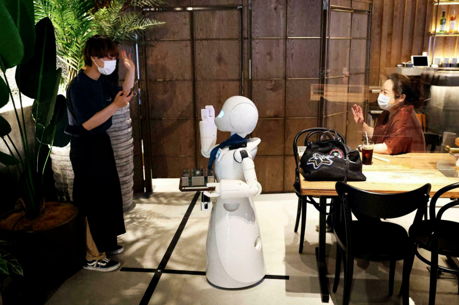 Một chú robot đang vẫy tay chào vị khách